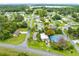 An aerial view of a community with lush landscaping and a lake in the distance at 6305 Bass Hwy, St Cloud, FL 34771