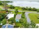 Aerial view showcasing a home with its proximity to a lake and surrounding neighborhood amenities at 6305 Bass Hwy, St Cloud, FL 34771