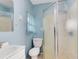 Cozy bathroom with shower, toilet, sink, and light blue walls at 6305 Bass Hwy, St Cloud, FL 34771