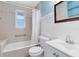 Clean and functional bathroom featuring a shower-tub combo, neutral tiles, and a classic white vanity for a refreshing space at 6305 Bass Hwy, St Cloud, FL 34771