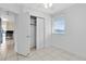 Bedroom with white walls, closet and view into kitchen with stainless steel appliances at 6305 Bass Hwy, St Cloud, FL 34771