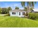 Cozy cottage-style house showcasing a neatly manicured lawn and charming curb appeal, ideal for a starter home at 6305 Bass Hwy, St Cloud, FL 34771