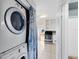 Conveniently placed laundry room with stackable washer and dryer, leading to the kitchen at 6305 Bass Hwy, St Cloud, FL 34771