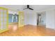 Inviting living room featuring hardwood floors, neutral walls, and bright yellow doors, perfect for relaxation and entertaining at 6305 Bass Hwy, St Cloud, FL 34771