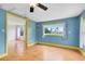 Bright living room with light blue walls, vibrant yellow trim, and views of the water at 6305 Bass Hwy, St Cloud, FL 34771