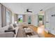 Bright living room featuring hardwood floors, a ceiling fan, and a view to the lake at 6305 Bass Hwy, St Cloud, FL 34771