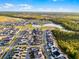 Extensive aerial view of a neighborhood with lush green spaces, homes, and serene lakes in a community at 6439 Trailblaze Bnd, St Cloud, FL 34771