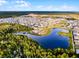 Vast aerial view of a neighborhood with lakes, green spaces, and suburban homes in a planned community at 6439 Trailblaze Bnd, St Cloud, FL 34771