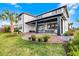 Charming backyard with a covered patio, lush lawn, and manicured landscaping for outdoor enjoyment at 6439 Trailblaze Bnd, St Cloud, FL 34771
