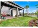 Beautiful backyard with lush green lawn, brick patio, and manicured landscaping for outdoor entertainment at 6439 Trailblaze Bnd, St Cloud, FL 34771