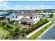 Aerial view of a home's backyard with a patio area, bordered by a black fence and a large pond at 6439 Trailblaze Bnd, St Cloud, FL 34771