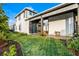 This home features a serene outdoor space with a covered patio and landscaped yard, perfect for relaxation at 6439 Trailblaze Bnd, St Cloud, FL 34771