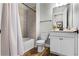 Cozy bathroom with tile shower and tub, white vanity, neutral paint and modern fixtures at 6439 Trailblaze Bnd, St Cloud, FL 34771