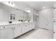 Modern bathroom featuring dual sinks, a large mirror, and a glass-enclosed shower at 6439 Trailblaze Bnd, St Cloud, FL 34771