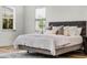 Bright bedroom featuring wood floors, a padded headboard and lots of natural light at 6439 Trailblaze Bnd, St Cloud, FL 34771