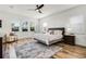 Bright bedroom featuring wood floors, a ceiling fan, and large windows with natural light at 6439 Trailblaze Bnd, St Cloud, FL 34771