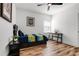 Bright bedroom with a ceiling fan, wood floors, desk, and natural light from the window at 6439 Trailblaze Bnd, St Cloud, FL 34771