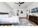 Modern bedroom with wood floors, a ceiling fan, and an en suite bathroom at 6439 Trailblaze Bnd, St Cloud, FL 34771