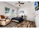 Bright bedroom with accent chair, tv, fan and two windows at 6439 Trailblaze Bnd, St Cloud, FL 34771