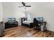 This spacious bedroom features wood floors, ceiling fan, and a dedicated computer space at 6439 Trailblaze Bnd, St Cloud, FL 34771
