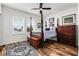 Inviting bedroom with a four-poster bed, wood floors, and plenty of natural light at 6439 Trailblaze Bnd, St Cloud, FL 34771