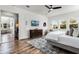 Spacious bedroom with wood floors, natural light, and access to other living areas at 6439 Trailblaze Bnd, St Cloud, FL 34771