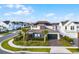 Two-story home featuring solar panels, a landscaped yard with palm trees, and a dark green two-car garage at 6439 Trailblaze Bnd, St Cloud, FL 34771