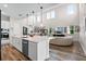 Spacious open-concept kitchen with white cabinets, island, and views into the living room at 6439 Trailblaze Bnd, St Cloud, FL 34771