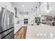 Bright modern kitchen featuring a large island with bar seating and stainless steel appliances at 6439 Trailblaze Bnd, St Cloud, FL 34771
