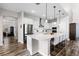 Modern kitchen with stainless steel appliances, white cabinets, and a large island with bar seating at 6439 Trailblaze Bnd, St Cloud, FL 34771