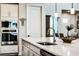 Bright kitchen island with stainless appliances, white cabinets, and modern fixtures at 6439 Trailblaze Bnd, St Cloud, FL 34771