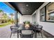 Covered outdoor patio with dining table and seating area at 6439 Trailblaze Bnd, St Cloud, FL 34771