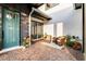 Cozy outdoor patio with brick pavers, comfortable seating, and lush plants create a relaxing atmosphere at 6439 Trailblaze Bnd, St Cloud, FL 34771