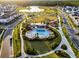This aerial image features a resort-style pool in a planned community with parks, playgrounds, and walking trails at 6439 Trailblaze Bnd, St Cloud, FL 34771