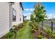Landscaped side yard with lush greenery, providing a peaceful walkway and enhanced curb appeal at 6439 Trailblaze Bnd, St Cloud, FL 34771