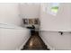 Wood stairs lead to a landing decorated with art and a black accent table at 6439 Trailblaze Bnd, St Cloud, FL 34771