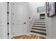 Stairway featuring wood stairs, a white handrail, and adjacent to two doorways at 6439 Trailblaze Bnd, St Cloud, FL 34771