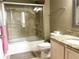 Well-lit bathroom features a shower with a glass door, double sink, and updated fixtures at 6575 Time Square Ave # 101, Orlando, FL 32835
