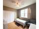 Bedroom with hardwood floors, closet, ceiling fan, and window with light filtering curtains at 6575 Time Square Ave # 101, Orlando, FL 32835