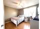 Light-filled bedroom with hardwood floors, neutral walls, and a comfortable bed setup at 6575 Time Square Ave # 101, Orlando, FL 32835