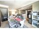 Open-concept dining room featuring a glass table, seating for six, and an adjacent kitchen area at 6575 Time Square Ave # 101, Orlando, FL 32835