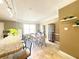 Bright dining area open to the kitchen with modern lighting and neutral decor at 6575 Time Square Ave # 101, Orlando, FL 32835