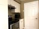 Bright kitchen featuring stainless steel appliances, granite countertops, and white cabinetry at 6575 Time Square Ave # 101, Orlando, FL 32835