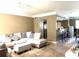 Inviting living room featuring an open floor plan and adjacent breakfast bar at 6575 Time Square Ave # 101, Orlando, FL 32835