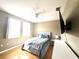 Cozy main bedroom features natural light, hardwood floors, and a ceiling fan at 6575 Time Square Ave # 101, Orlando, FL 32835
