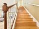 Classic wooden staircase with white spindles and a stained wood handrail leading to the upper level at 6575 Time Square Ave # 101, Orlando, FL 32835