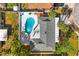 Aerial view of the home, showcasing the roof, pool, landscaping, and driveway at 7320 Fieldcrest Ave, Winter Park, FL 32792