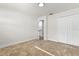 A clean, carpeted bedroom with double closet doors and a glimpse into the hallway at 7320 Fieldcrest Ave, Winter Park, FL 32792