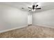 This cozy bedroom features neutral carpet, ceiling fan, and ample natural light at 7320 Fieldcrest Ave, Winter Park, FL 32792