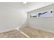 Bright, empty bedroom featuring neutral carpet, double windows and white trim at 7320 Fieldcrest Ave, Winter Park, FL 32792